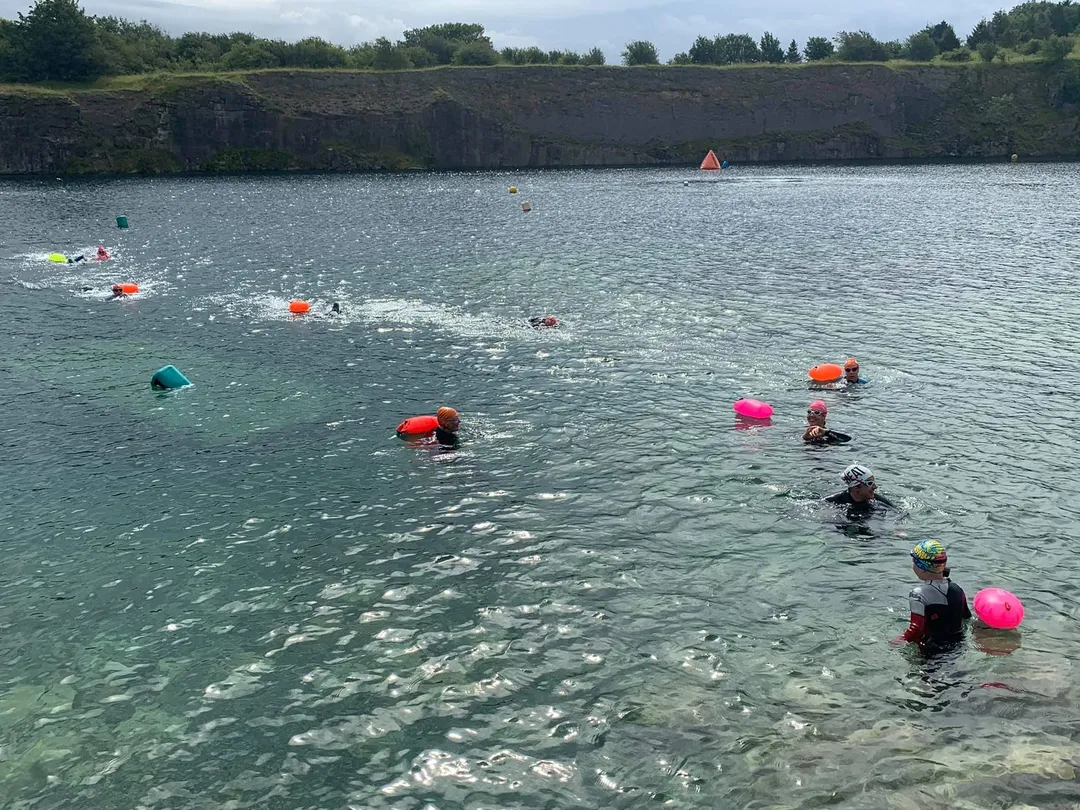 Junior triathletes swimming in open water during training